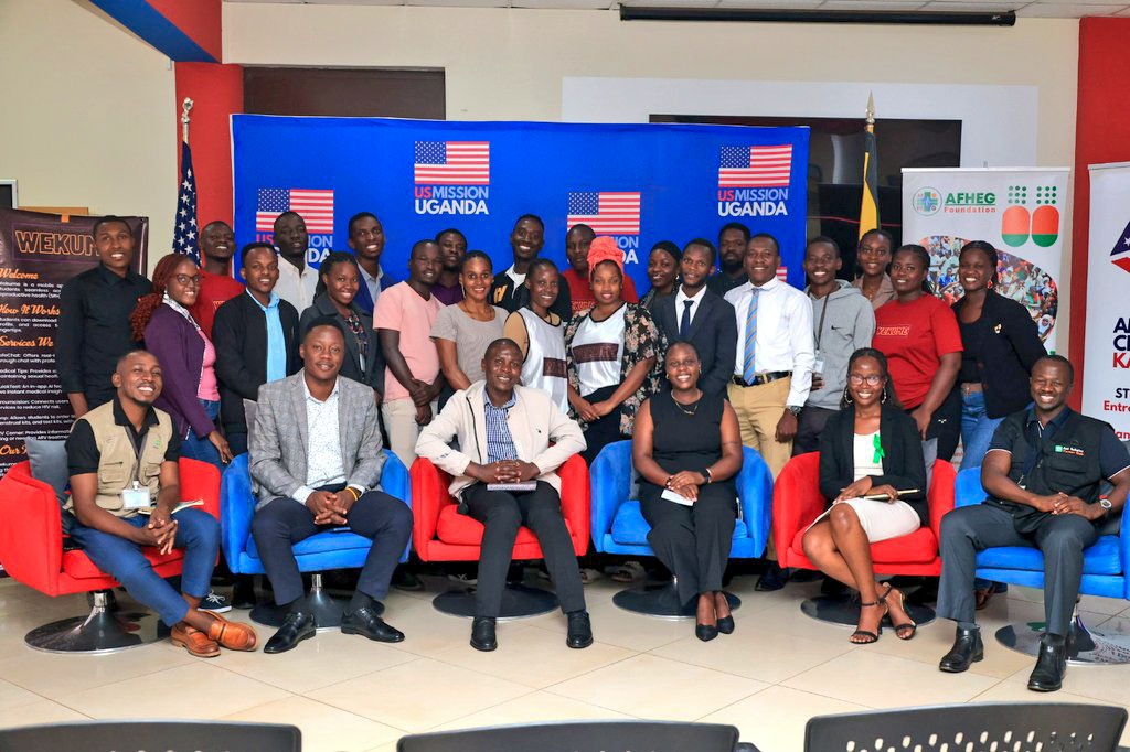 Participants together with panellists pose for a group photo after the Pre Summit Dialogue that was held at the American Centre in Kampala, Uganda